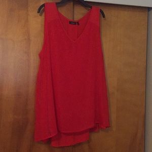 Red sleeveless tunic.